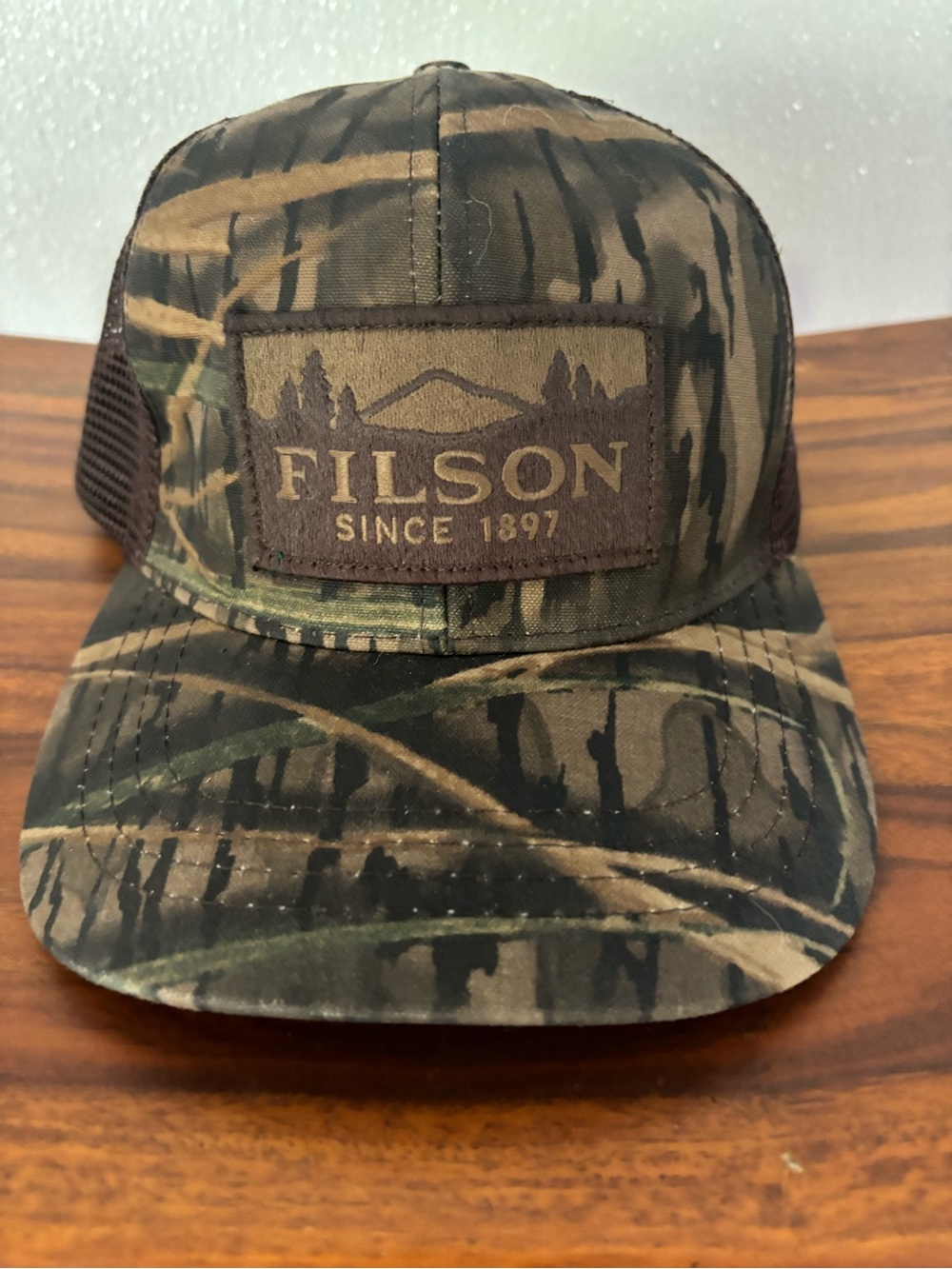 Filson X Mossy Oak Shadow Grass Camo Mesh Back Trucker Cap with leather strap
